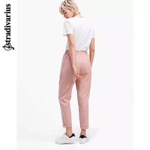 Stradivarius pink pants with white stripe.